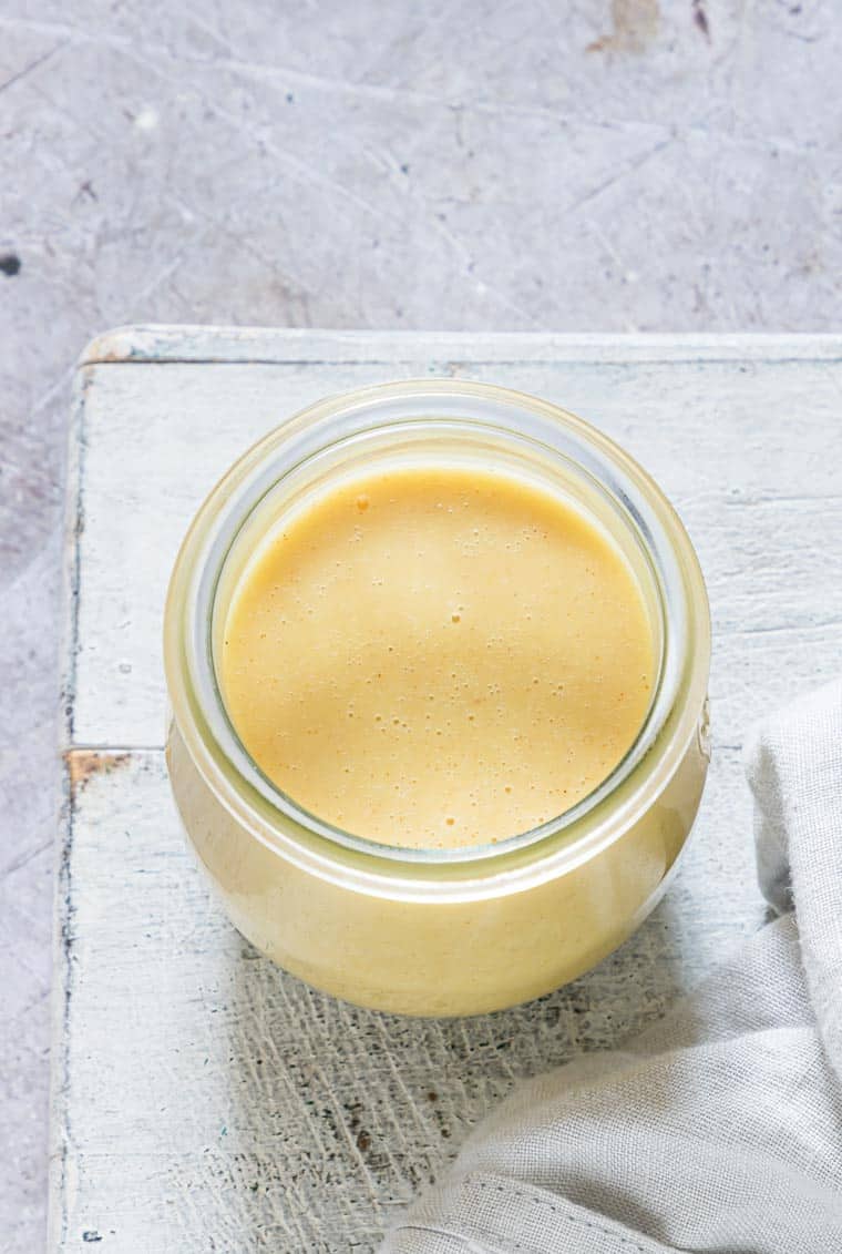 the completed honey mustard sauce in a storage jar