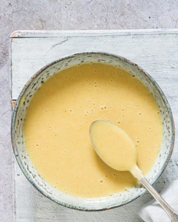 honey mustard sauce served in a blue ceramid dish with a spoon