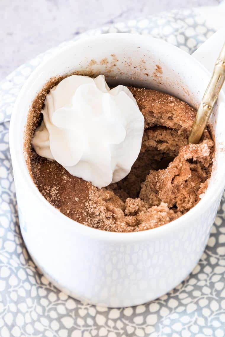 snickerdoodle mug cake topped with whipped cream