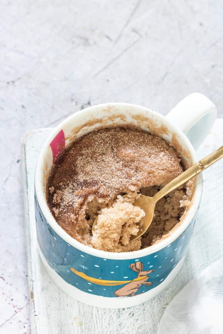 a spoon removing a bite of snickerdoodle mug cake