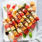 watermelon skewers on a boards with a teaspoon