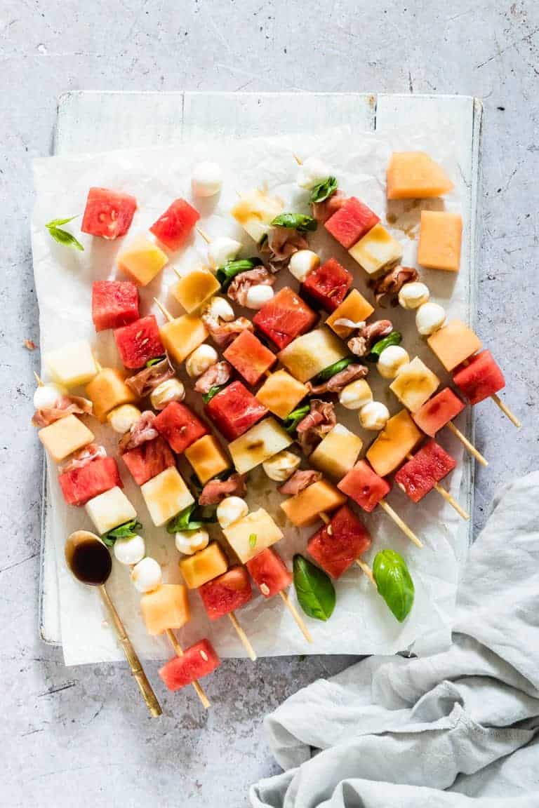 watermelon skewers on a boards with a teaspoon