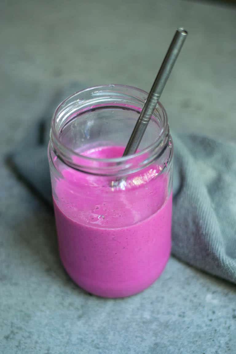 the finished dragon fruit smoothie in a glass jar and ready to serve