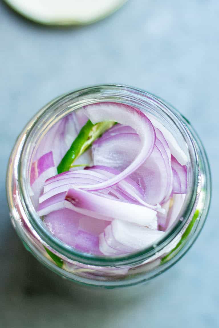 top down view of a jar filled with pickled onions