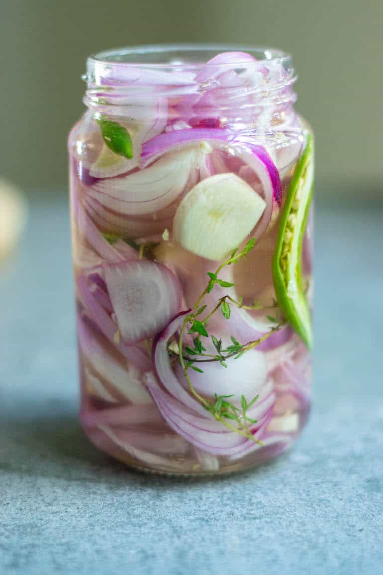 glass mason jar filled with pickled onions