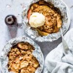 2 bowls of campfire apple crisp foil packets with ice cream