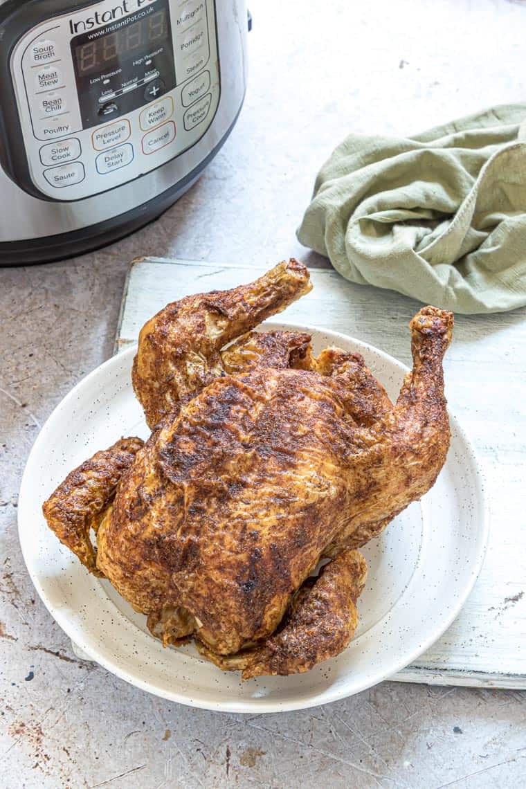 instant pot cornish hen on a white plate and ready to be served