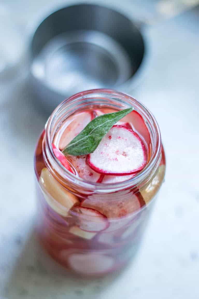 top down view of a jar filled with pickled radishes