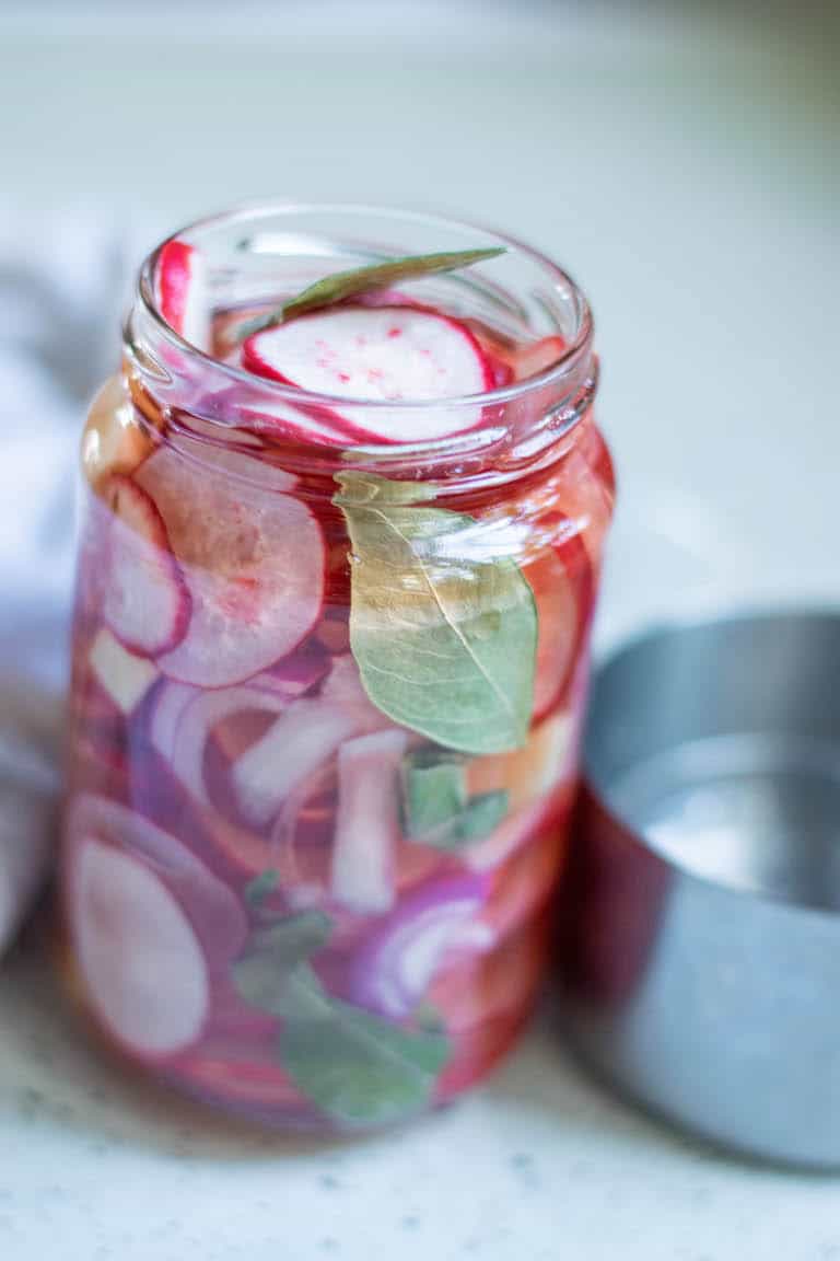a jar of quick pickled radishes
