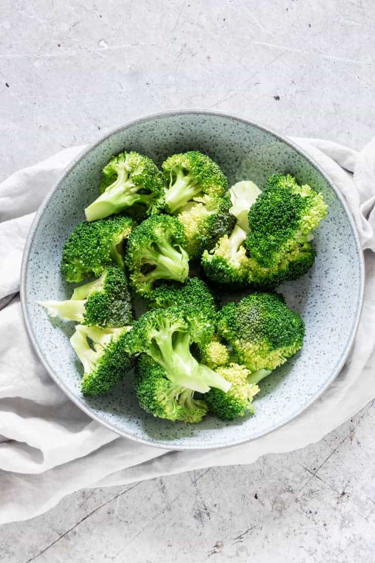 Bowl of instant pot broccoli on a table