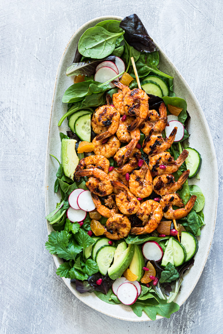 the finished harissa grilled shrimp salad with shrimp, avocado, cucumber, radishes and more