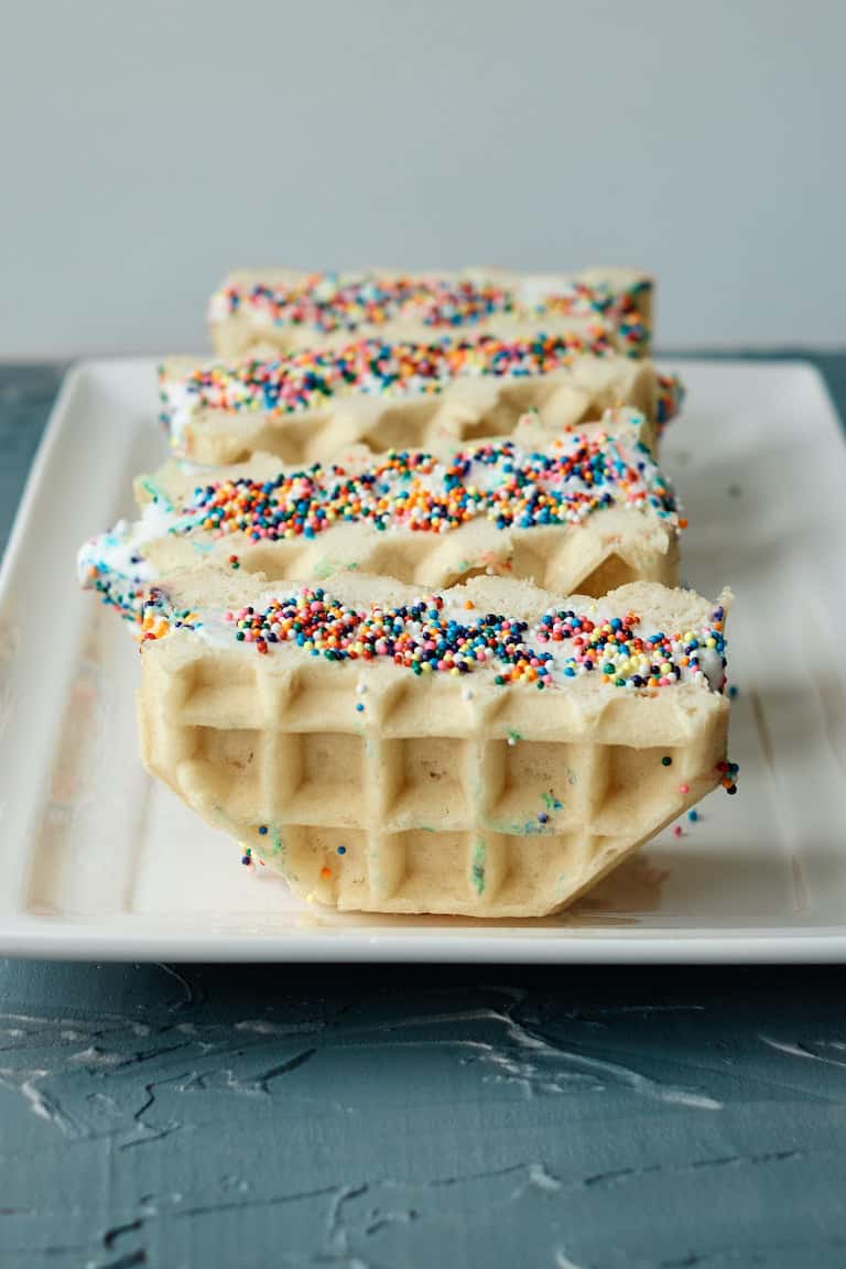 four servings of waffle ice cream sandwich served on a white tray