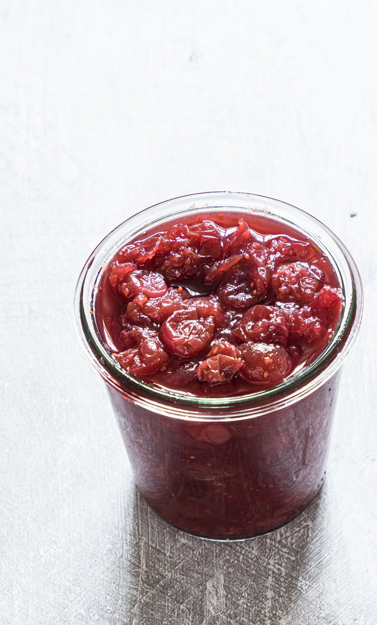 instant pot cranberry sauce inside a glass storage container