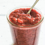 instant pot strawberry jam inside a glass jar with a spoon