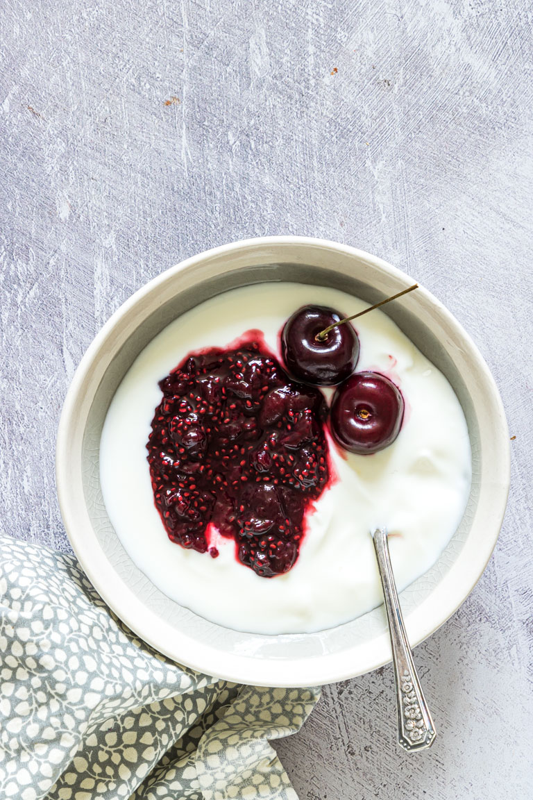 a bowl of yogurt topped with instant pot cherry jam