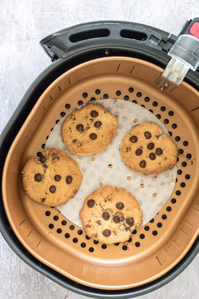 top down view of air fryer chocolate chip cookies in the airfrtyer basket