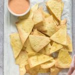 the finished air fryer tortilla chips served with dipping sauce