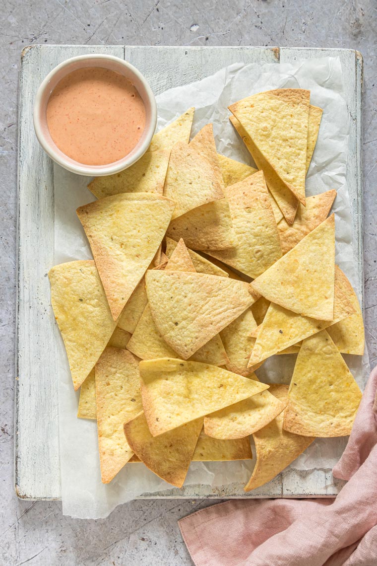 the finished air fryer tortilla chips served with dipping sauce