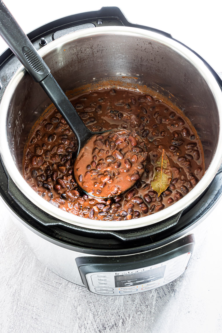 the finished instant pot black beans stew inside the instant pot