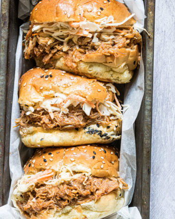 three instant pot pulled chicken sandwiches served in a tray