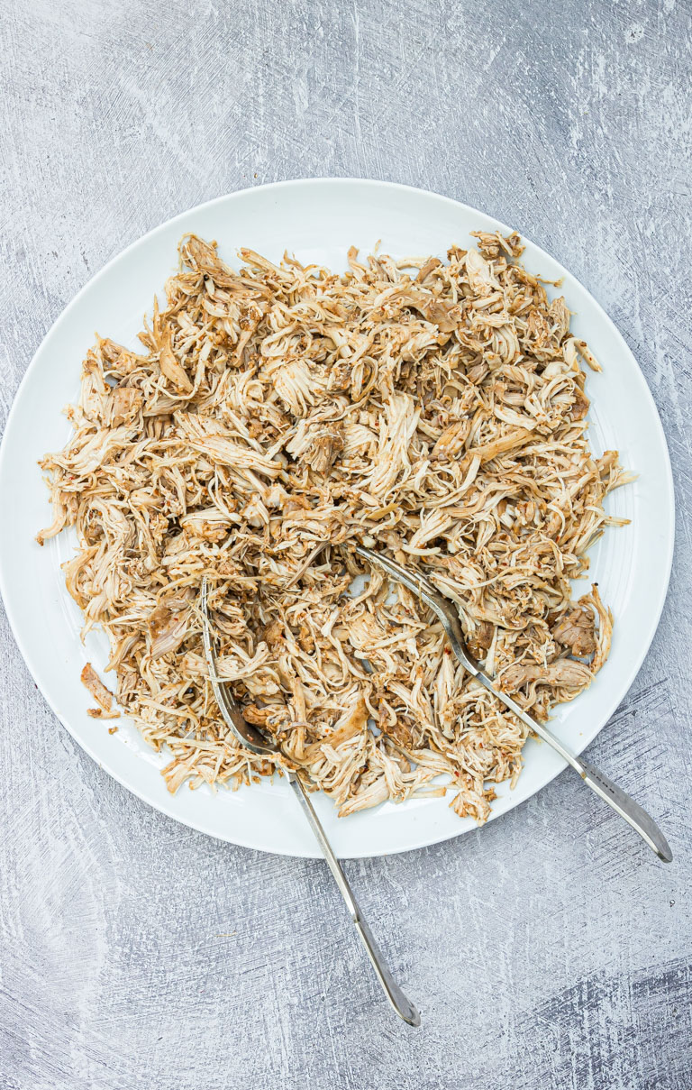 close up of juicy instant pot shredded chicken on a plate