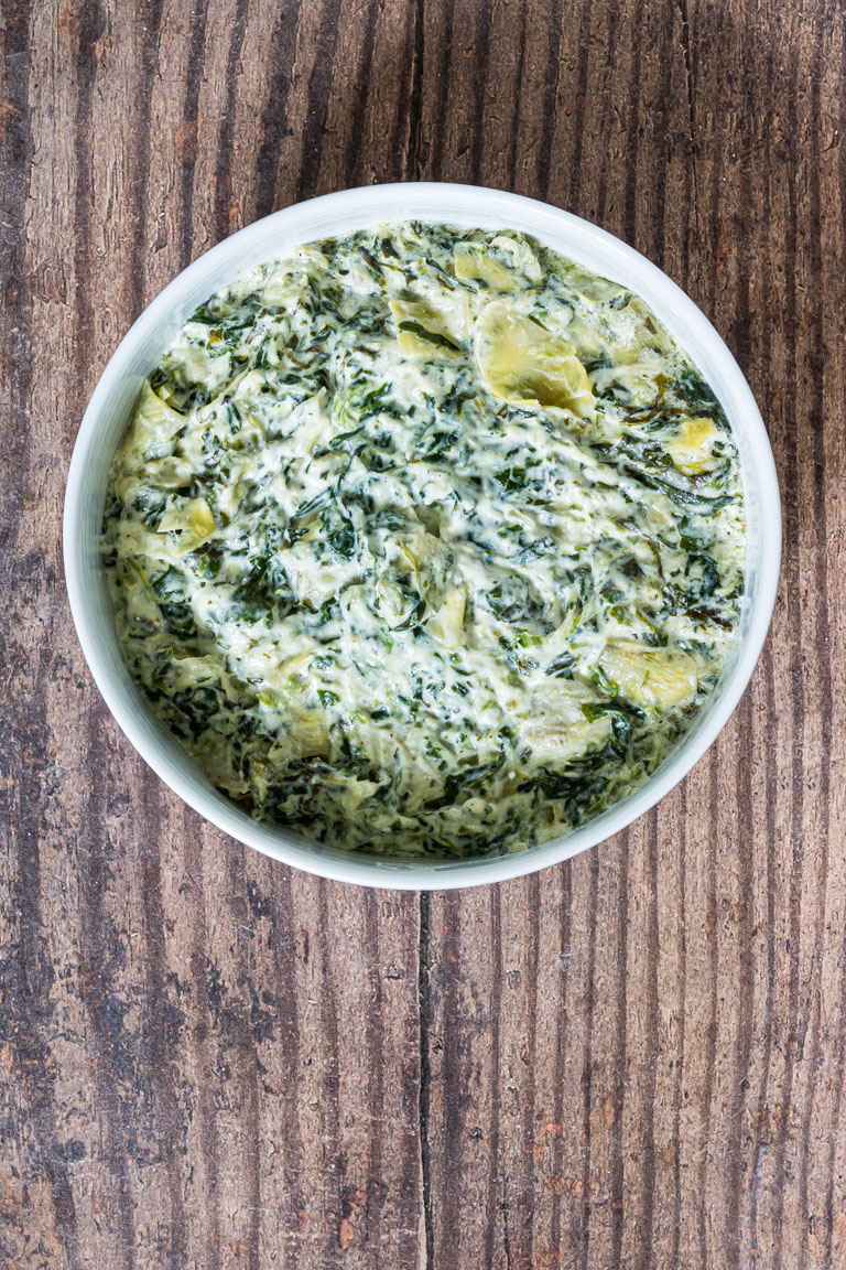 a bowl of the completed instant pot spinach artichoke dip recipe