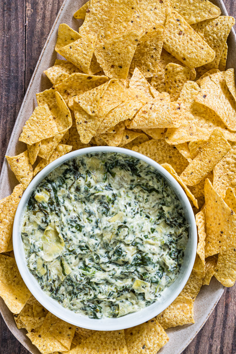 the finished instant pot spinach artichoke dip served with tortilla chips