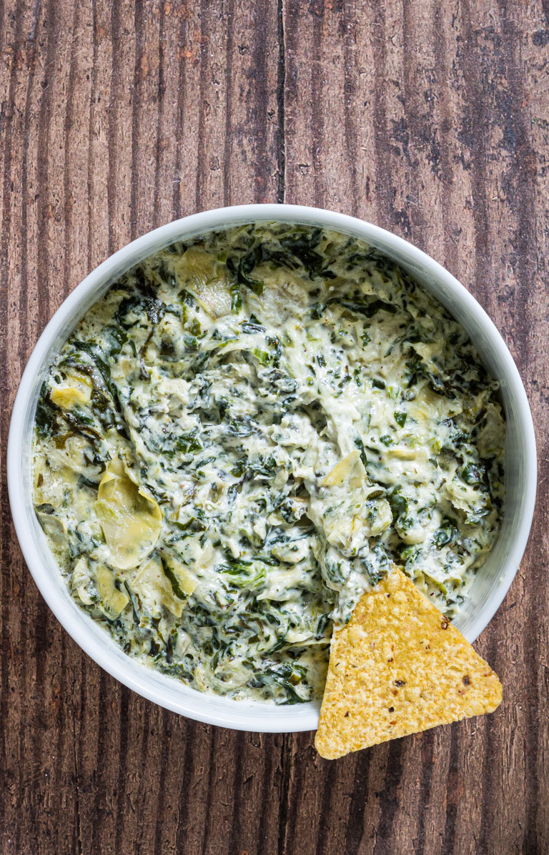 top down view of a bowl filled with instant pot spinach artichoke dip