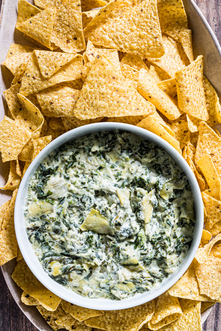 close up view of instant pot spinach artichoke dip with tortilla chips