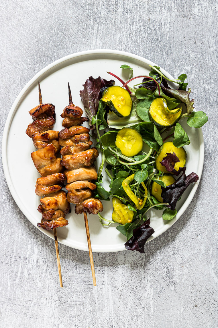 air fryer chicken kabobs served on a white plate with salad