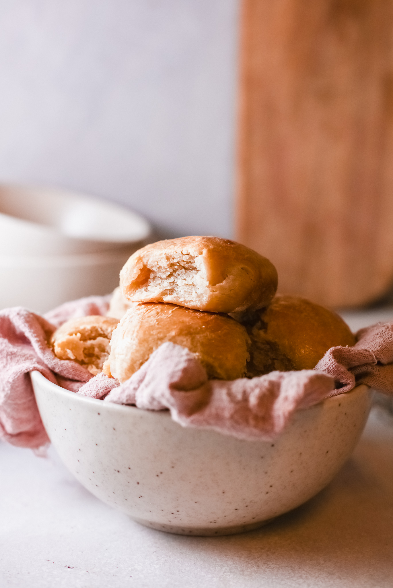 completed instant pot dinner rolls served in a bowl lined with a cloth towel