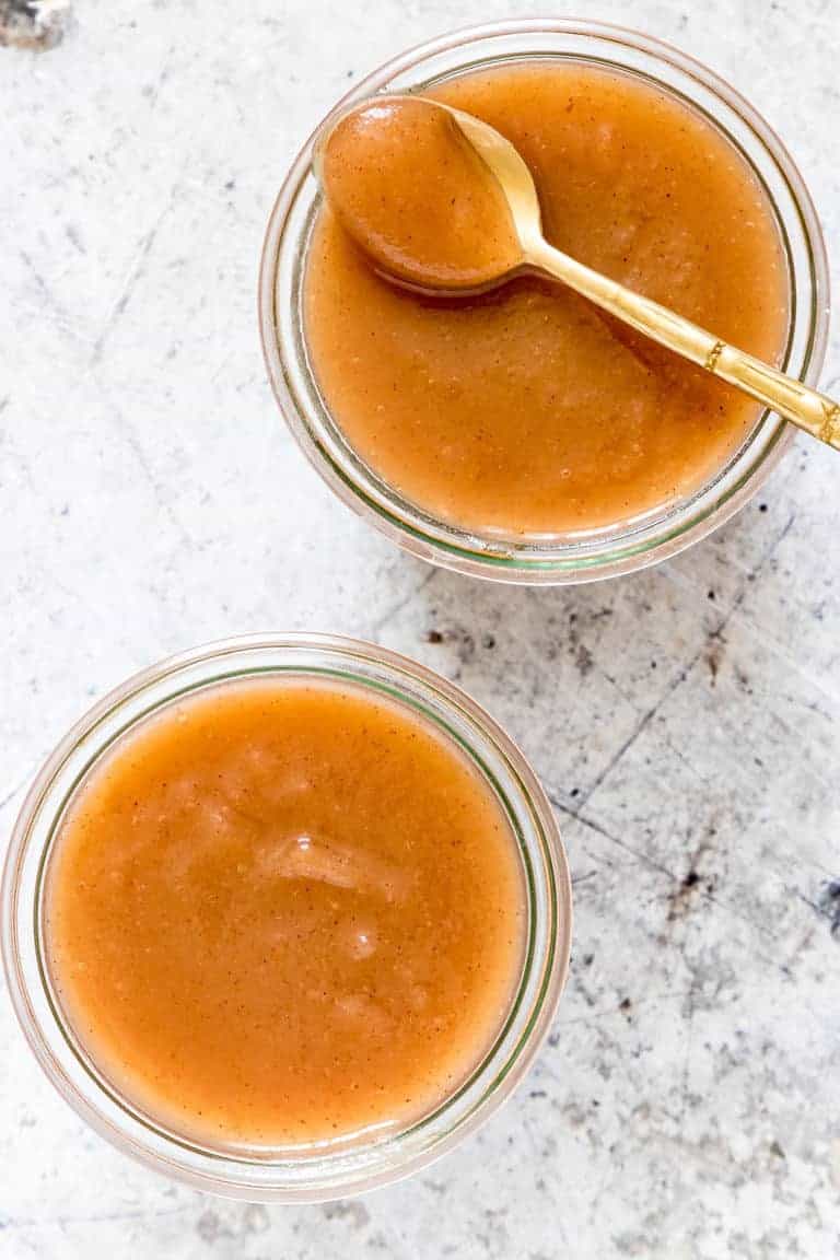 2 jars of instant pot applesauce with a teaspoon
