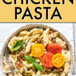 a round bowl of tuscan chicken pasta topped with sliced tomatoes and basil leaves