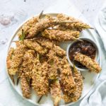 air fryer okra on a white plate with dipping sauce