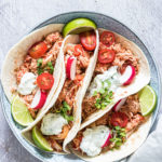 crockpot chicken fajitas served in tortillas with radishes and lime wedges