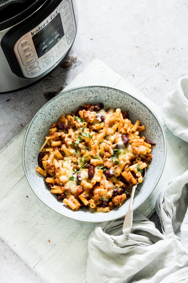 bowl of chili mac set next to the instant pot