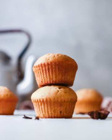 two pumpkin spice muffins stacked on top of each other