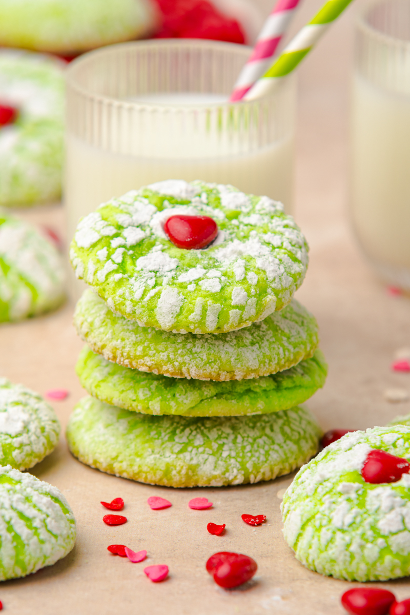 Stacked green cookies with decorations.