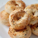 the completed air fryer bagels served on a white plate