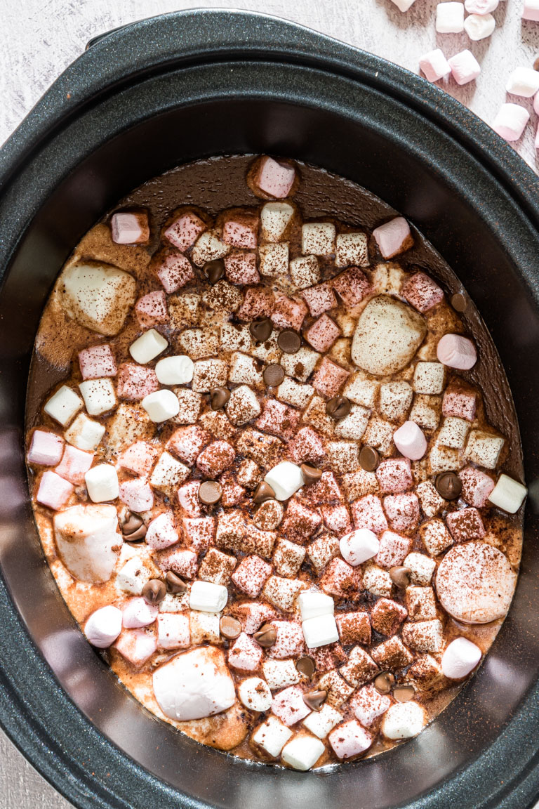 close up view of hot chocolate inside the crockpot and topped with marshmallows