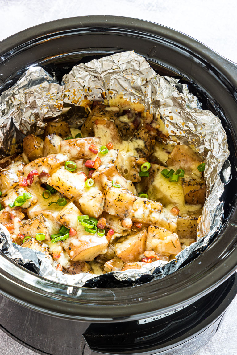 the cooked cheesy potatoes inside the crock pot