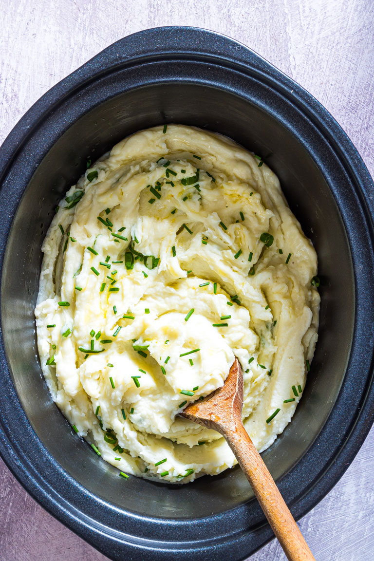 the completed mashed potatoes inside the crockpot and ready to be served