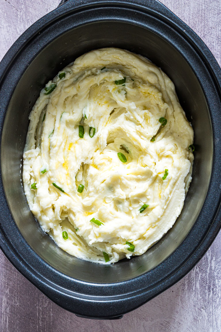 top down view of the crock pot mashed potatoes inside the crockpot