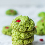 four grinch cookies stacked on top of one another