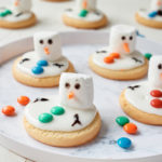 the completed melted snowman cookies served on a white round platter