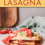 taco lasagna on a plate garnished with tomatoes