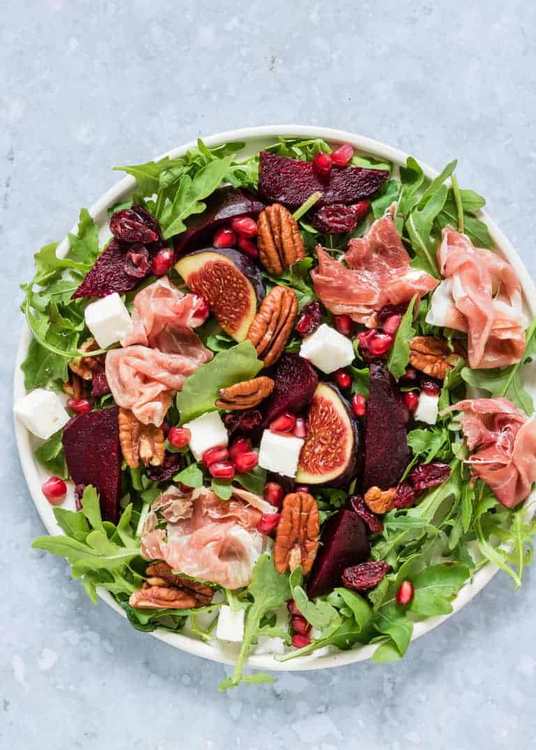Assembled Parma Ham and beet Salad on a large white plate