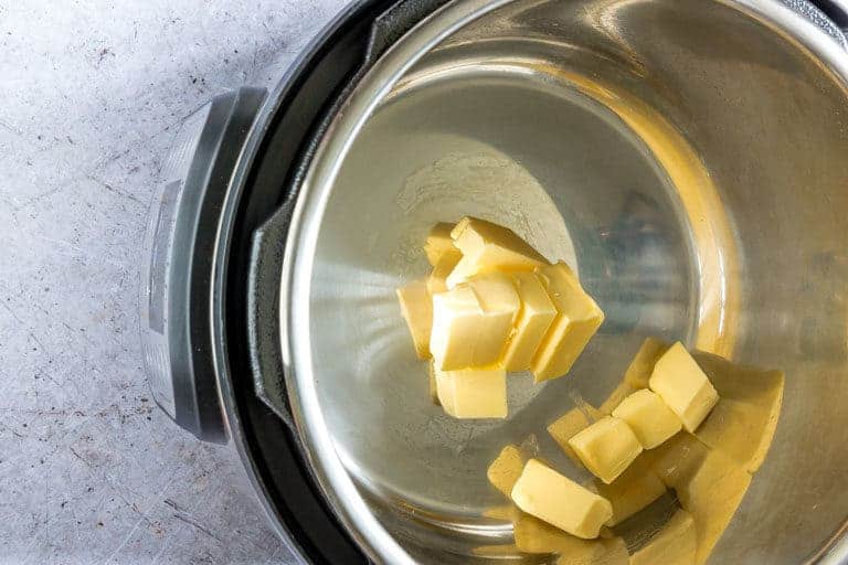 Cubed butter added to the Instant Pot Inner Pot to make Lemon Butter Sauce