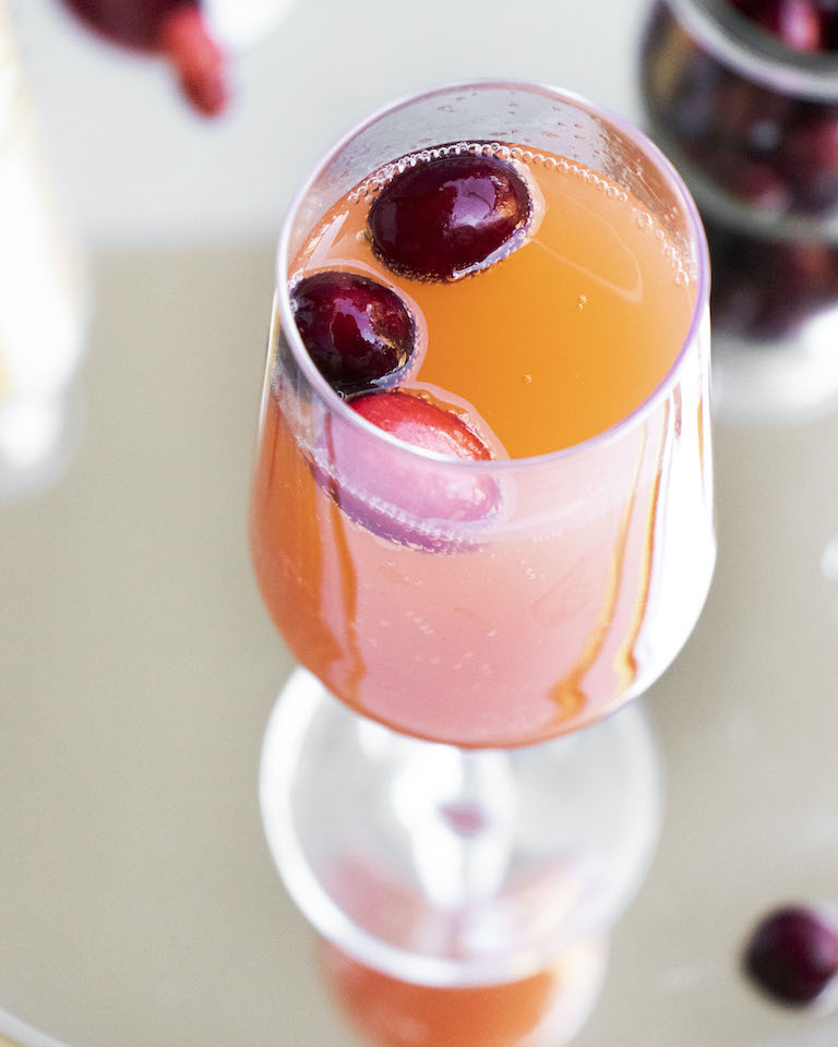 close up view of one cranberry orange mimosa cocktail