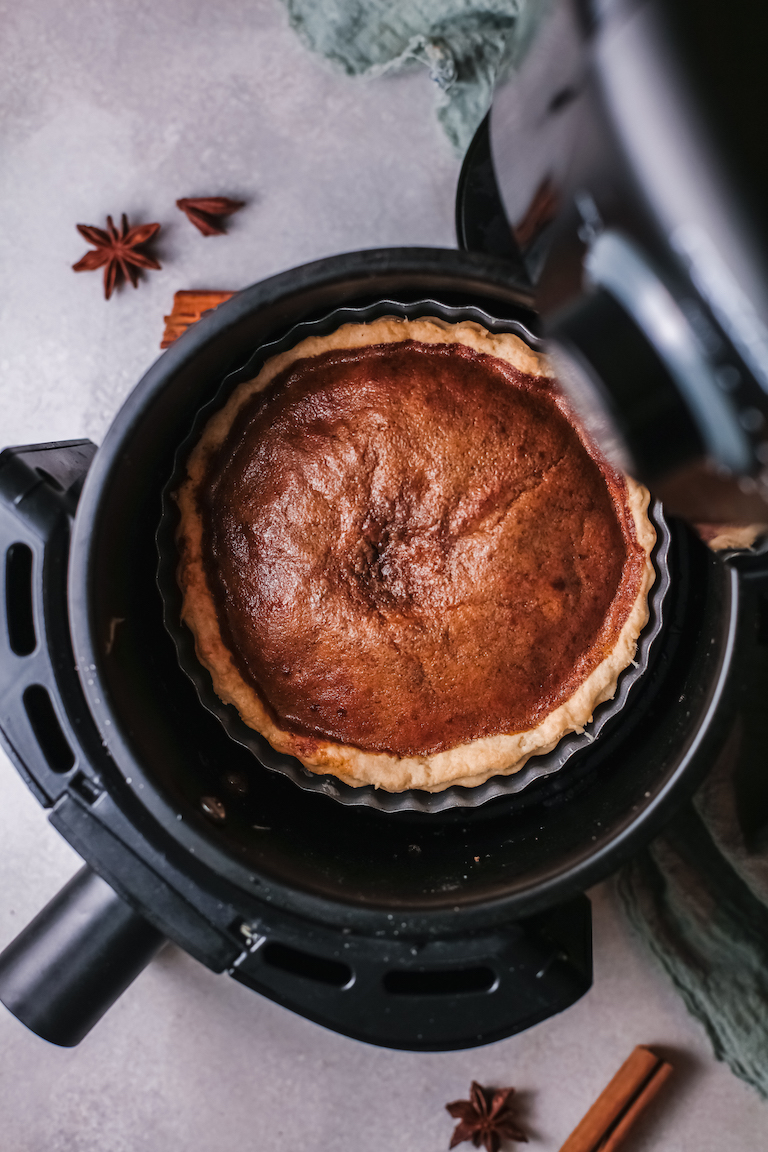 the finished sweet potato pie recipe inside the air fryer basket